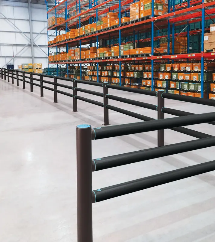A-SAFE three-rail cold-storage barrier defining a protected route beside warehouse racking