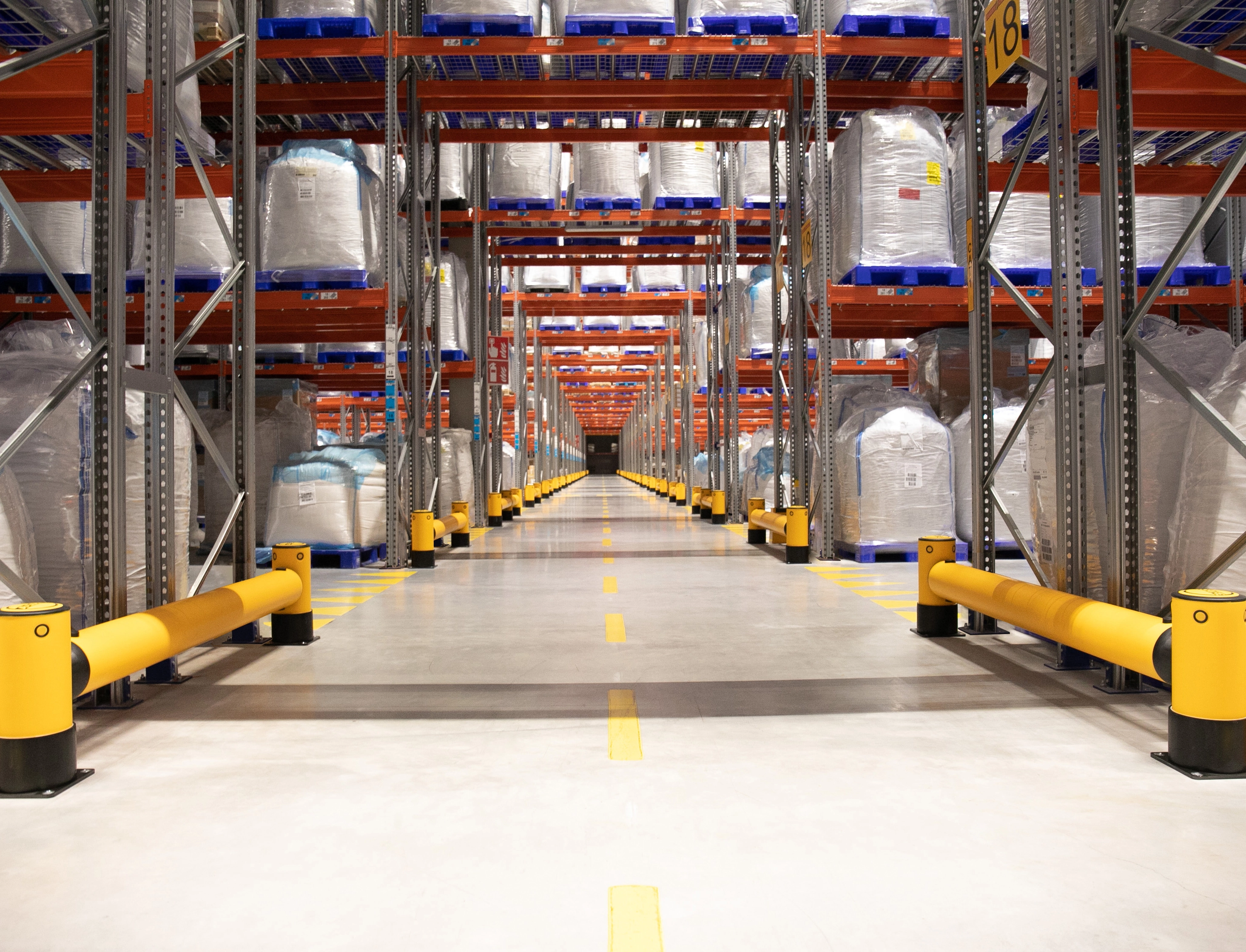 Long A-SAFE Barrier Installation Protecting Warehouse Racking And Distribution Aisles