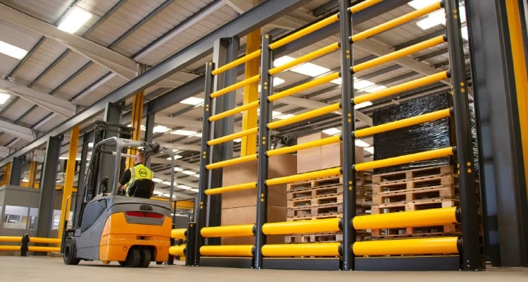 A-SAFE Topple Guard protecting tall stored materials beside an active forklift route