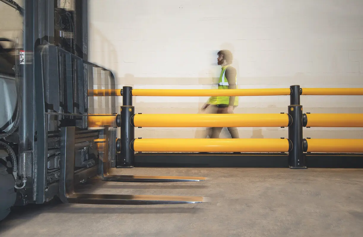 Pedestrian walkway separated from forklift traffic by an A-SAFE barrier