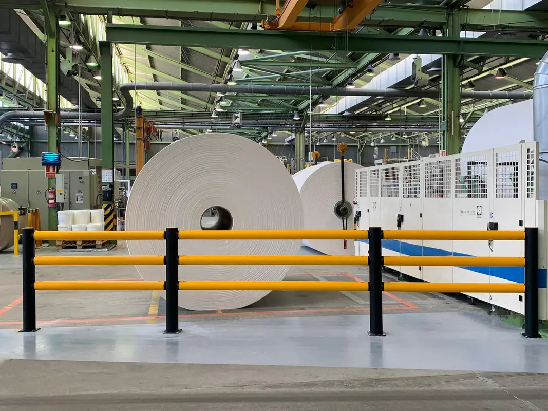 Large paper rolls positioned behind an A-SAFE traffic barrier